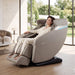 Titan Forma 3D+2D massage chair in Taupe with model - MassageChairPlanet.com